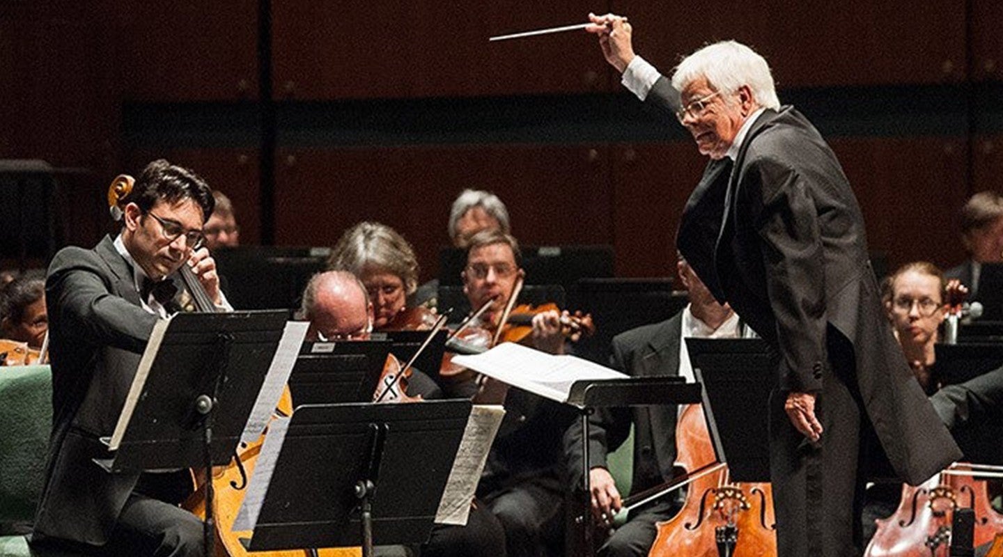 A conductor leads the orchestra at the Eugene Bach Festival