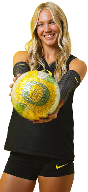 a volleyball player holding a UO-branded volleball
