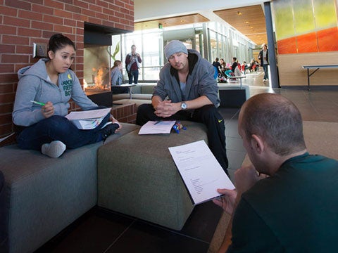 Students studying by the fireplace in the HEDCO building Students studying by the fireplace in the HEDCO building
