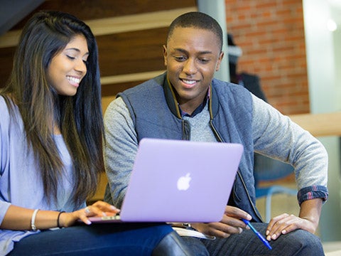 Two students looking at a computer Two students looking at a computer