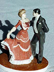 A Victorian lady and gentleman dancing at a ball
