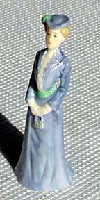 Prim lady of 1902 in light blue gown.