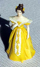 Lady of 1833 in flowing yellow gown.