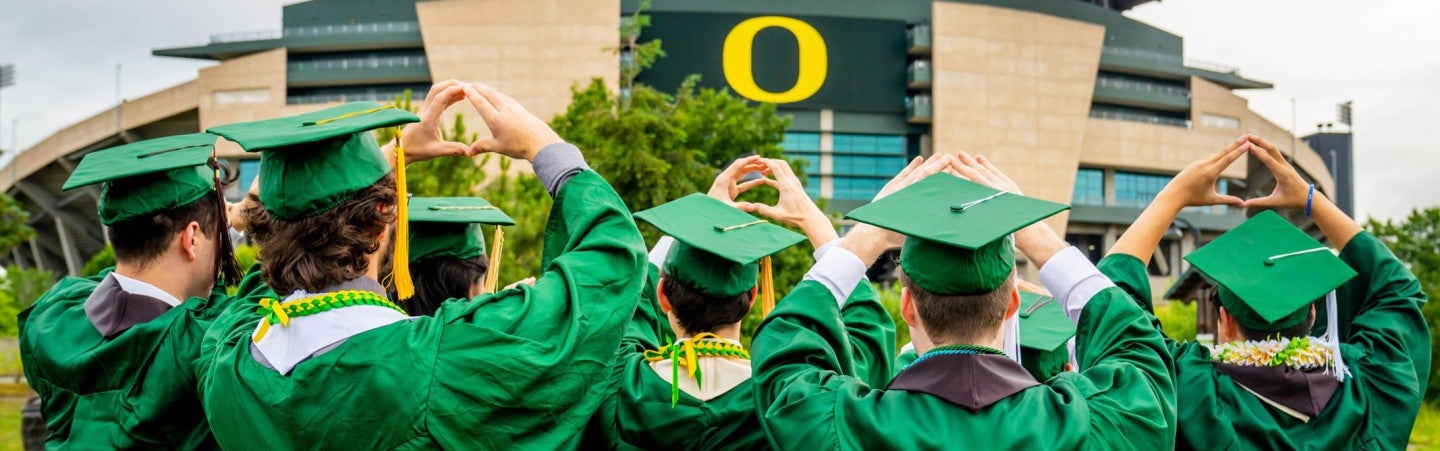 UO graduates in front of Autzen Stadium