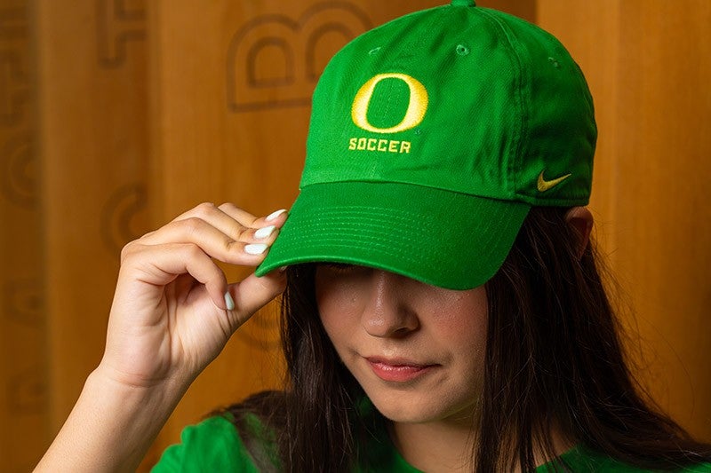 a person wearing a UO soccer cap