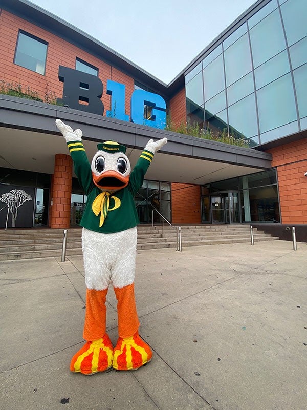 The Oregon Duck posing for a photo outside of the Big Ten Headquarters