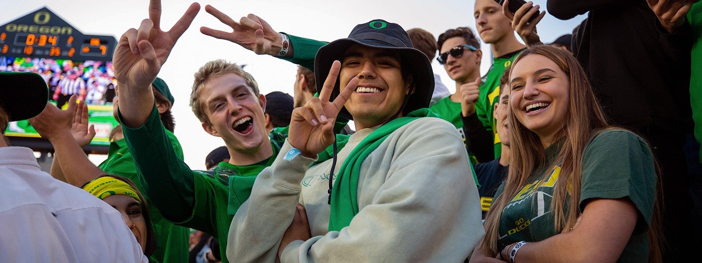 group of students smiling and cheering