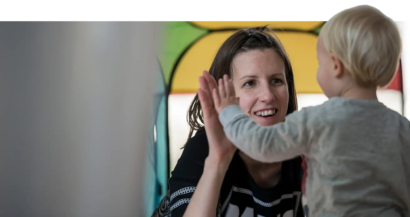 A parent high-fives with a child