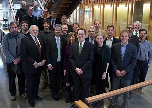 Group photo of faculty members with President Michael Schill and Board of Trustees Chair Chuck Lillis