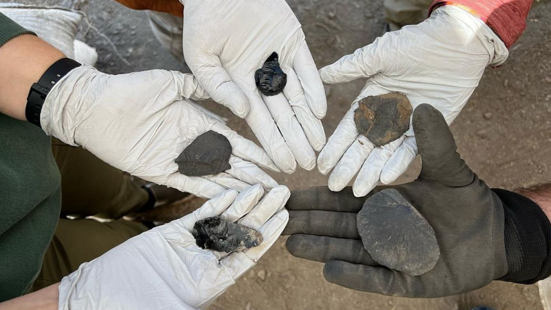 students holding ancient artifacts